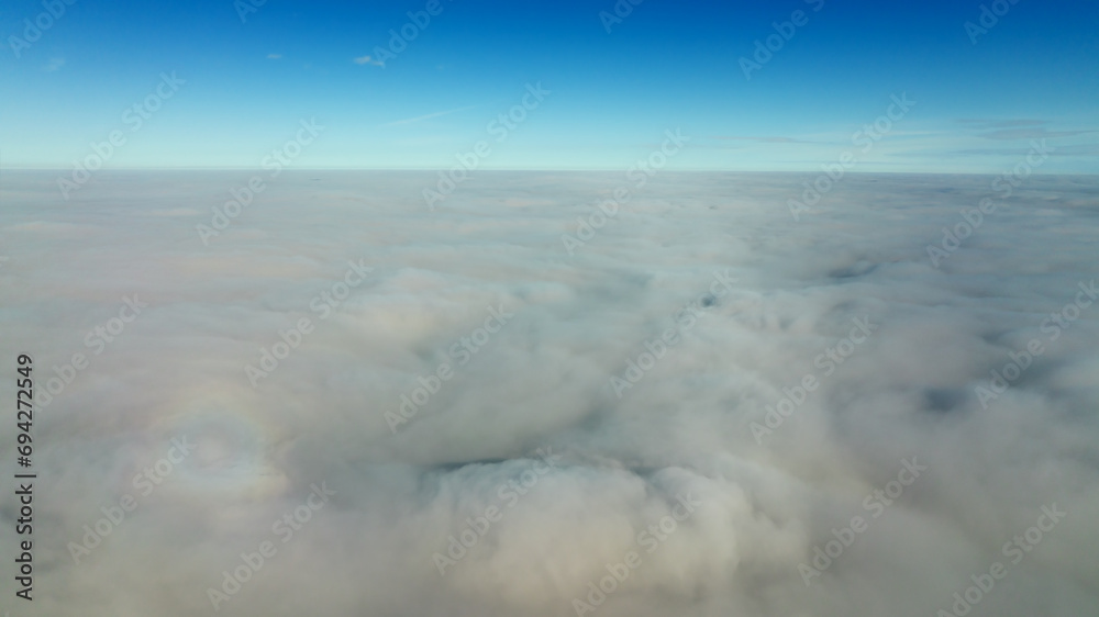 CFlying high above the clouds. Aerial view of clouds and horizon from drone. Thunderclouds from above before rain. Tragic gloomy natural landscape of horihonta at bird's eye view