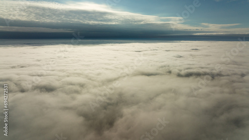 CFlying high above the clouds. Aerial view of clouds and horizon from drone. Thunderclouds from above before rain. Tragic gloomy natural landscape of horihonta at bird s eye view