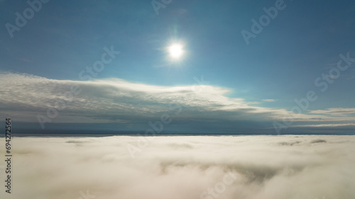 CFlying high above the clouds. Aerial view of clouds and horizon from drone. Thunderclouds from above before rain. Tragic gloomy natural landscape of horihonta at bird's eye view