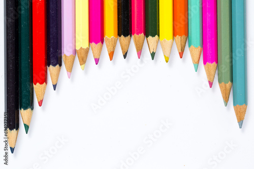 Lots of colored pencils for drawing on a white background photo