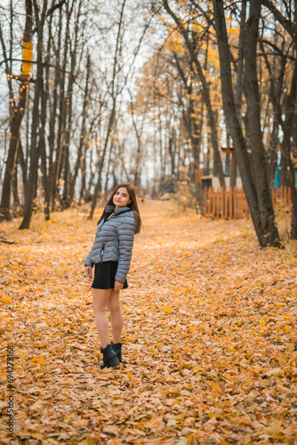 Rear view portrait of diversity young beautiful confident Indian Asian woman in fall outdoor. Happy and natural smiling female. Generation z and gen z youth concept