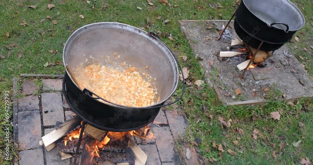 Preparation of bean soup in a cauldron on the open fire in nature Preparation of bean soup in a cauldron on the open fire in nature