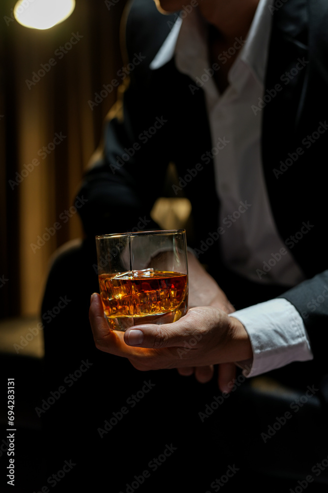 businessmen holding a glass of whiskey