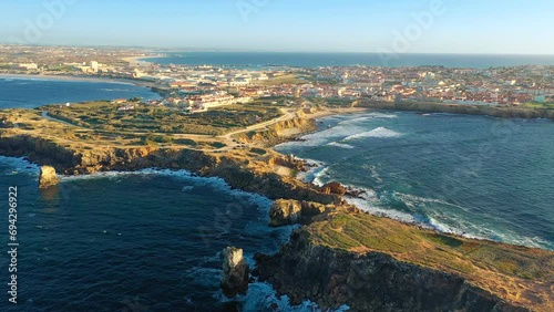 Drone approach and fly over Peniche, town, cliffs and sunset, Portugal