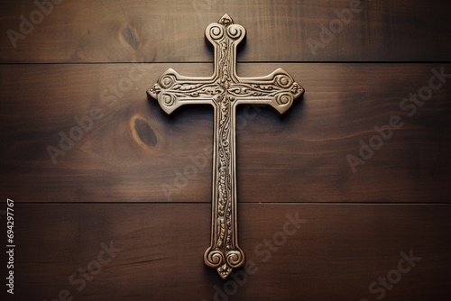Wooden christian cross on a wooden background.Christian religion concept. photo