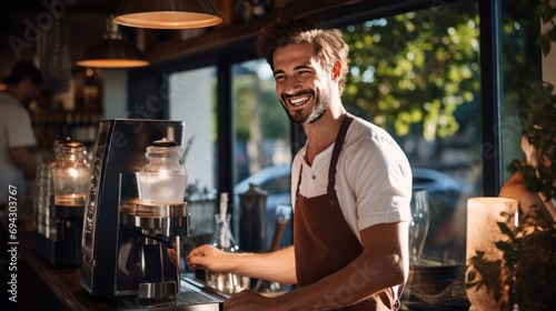 Smiling male bartender prepares drinks using a coffee maker in a coffee shop.