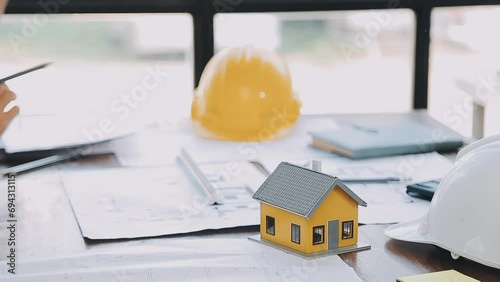 Hands of architect or engineer working on blueprint meeting for project working with partner on model building and engineering tools in working site, Construction and structure concept. photo