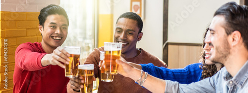 Horizontal banner or header with happy friends drinking beer at pub bar - Multiethnic lifestyle concept with genuine people enjoying time together eating and drinking beer at colorful pub hall photo
