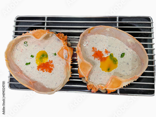 Japanese Crab meat with flying fish eggs,(Zuwai Kani Miso) It is grilled in a crab shell.  Isolated with background. photo