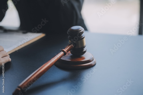 Business and lawyers discussing contract papers with brass scale on desk in office. Law, legal services, advice, justice and law concept picture with film grain effect