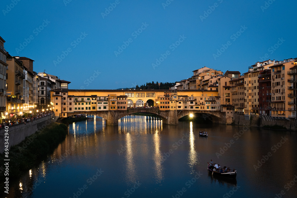 Ponte Vecchio in Florence, Italy at sundown as people prepare for Fochi di San Giovanni