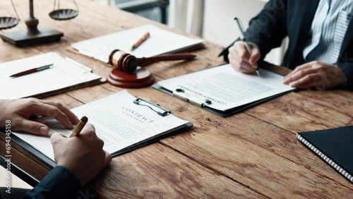 Attorney gives the client a pen to sign a contract admitting fraud, lawyer admits a fraud case in which client is a victim and will sue defendant who is a commercial partner. Fraud litigation concept. photo