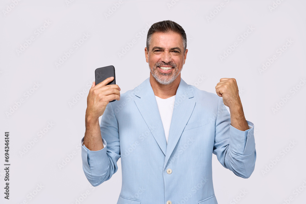 Happy middle aged business man entrepreneur, excited older professional businessman winner investor holding mobile phone celebrating online money win on smartphone isolated on white background. Happy middle aged business man entrepreneur, excited older professional businessman winner investor holding mobile phone celebrating online money win on smartphone isolated on white background.