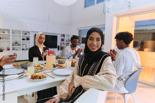 In the sacred month of Ramadan, a diverse Muslim family comes together in spiritual unity, fervently praying to God before breaking their fast, capturing a moment of collective devotion, cultural photo