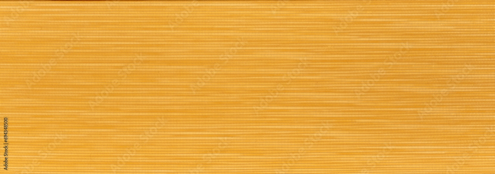 An orange textured background made of fabric material. An orange textured background made of fabric material.