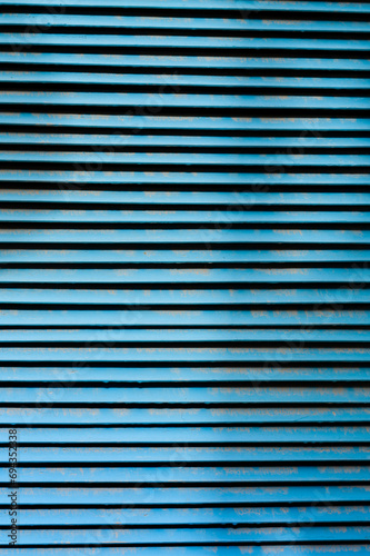 Abstract detail of blue metal slats on a utility closet