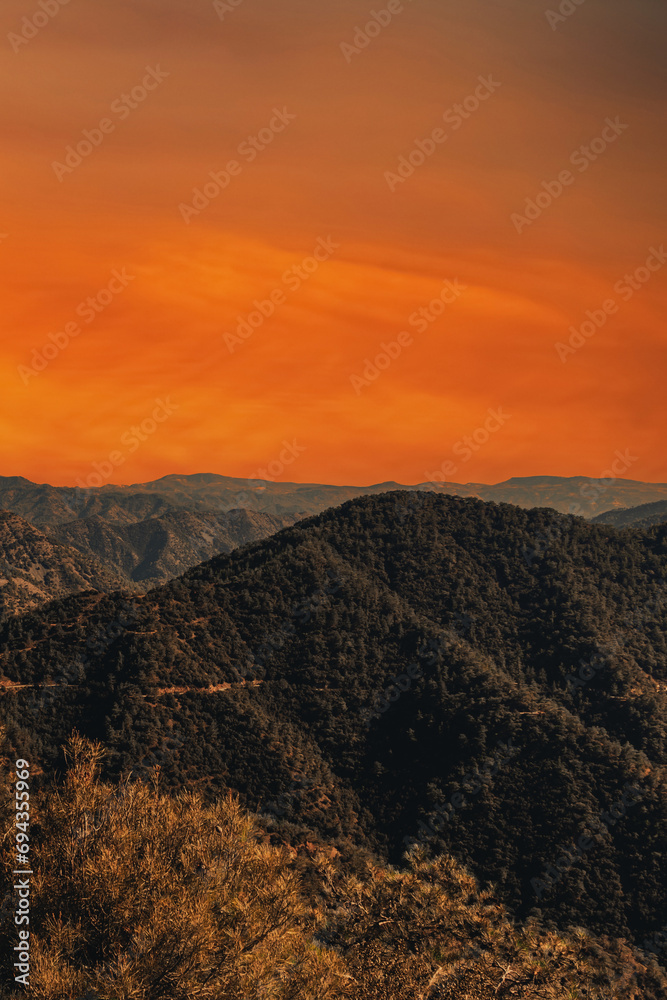 Mountain landscape at sunset. View of big mountains at sunset with bright orange sky