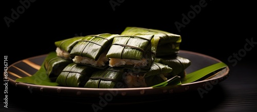 Kuih Koci is a Malaysian dessert made with rice flour, coconut, and palm sugar. It is wrapped in banana leaves for a unique scent. photo