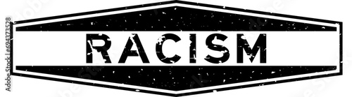 Grunge black racism word hexagon rubber seal stamp on white background