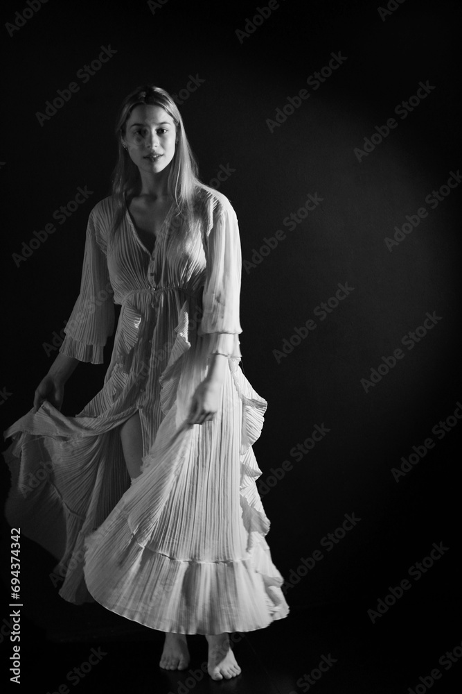 Low key portrait of young beautiful woman in vintage dress