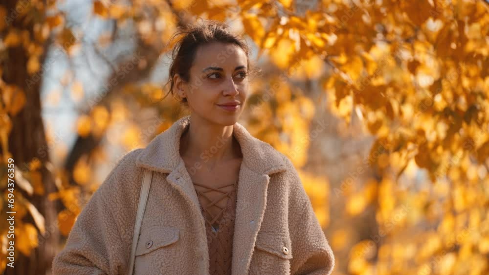 autumn portrait of beautiful stylish woman wearing in brown pants, sweater and cozy bomber jacket walking autumn park outdoors. girl on red and orange leaves background at sunny warm fall season day autumn portrait of beautiful stylish woman wearing in brown pants, sweater and cozy bomber jacket walking autumn park outdoors. girl on red and orange leaves background at sunny warm fall season day