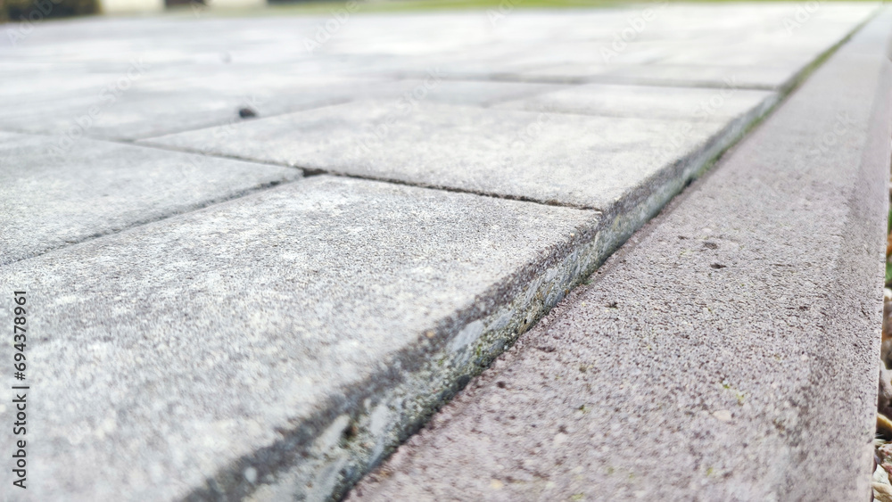  Detailed texture of uniformly paved grey bricks in a surface road.