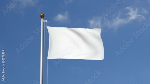 White flag flying on a flagpole photo