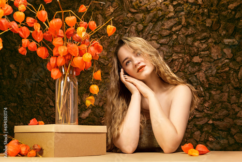 Girl with fesalis. A girl and a natural bouquet of orange dried flowers.  Natural rural look. photo