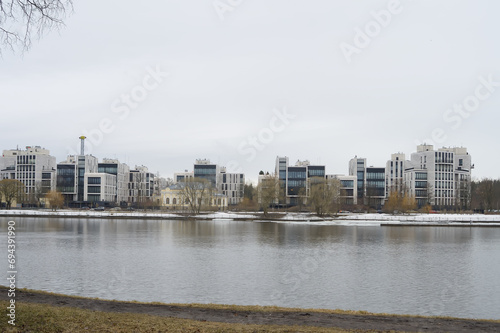 A view from the river bank to multi -storey beautiful buildings in a modern single style