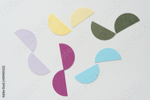 cut paper circle halves on blank paper