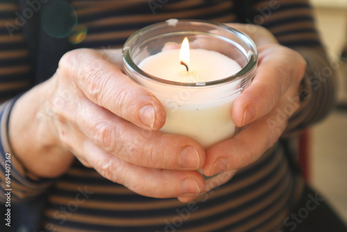 Woman holding candle. Christmas ceremony.
