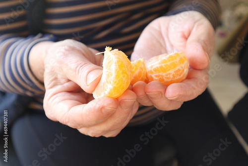 Woman holding organic tangerine fruit