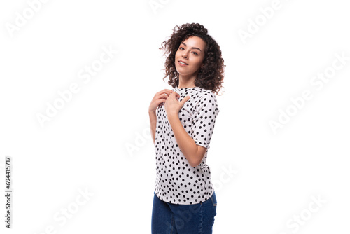 portrait of an authentic curly young brunette with shoulder-length hair dressed in a blouse on a white background with copy space photo