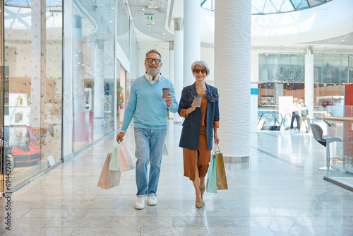 Fashionable elderly couple enjoying shopping tour on weekends