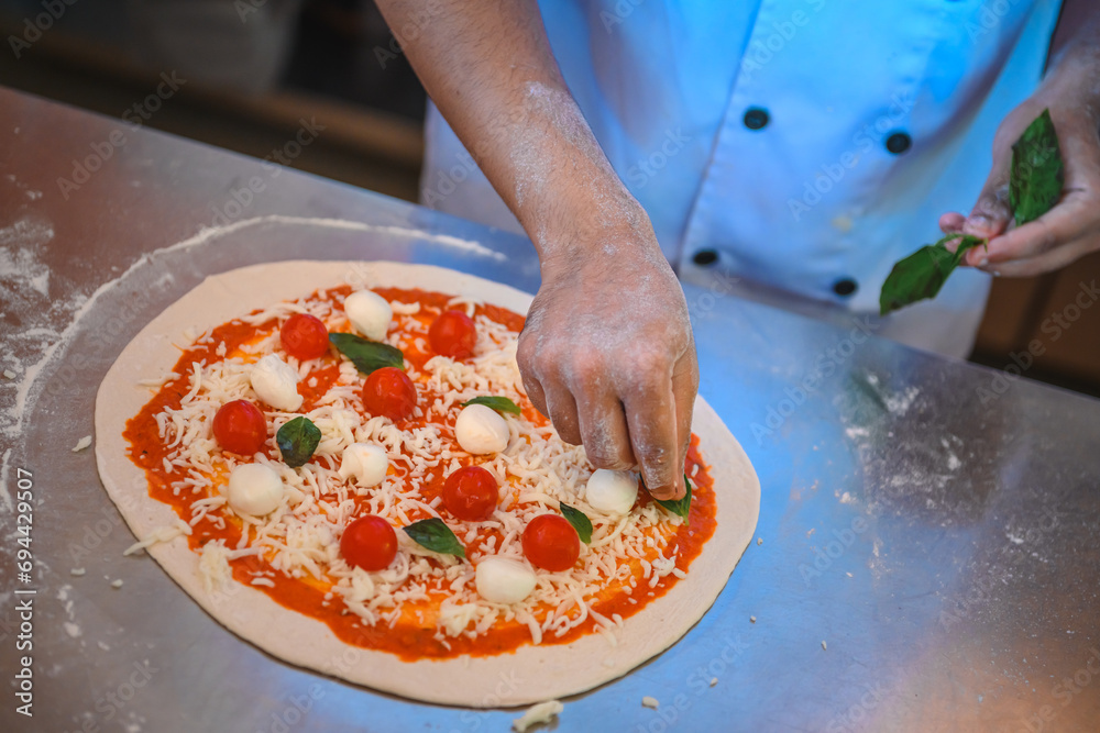 pizza preparation, pizza ingredients, chef's hand, restaurant product photography, italian pizza