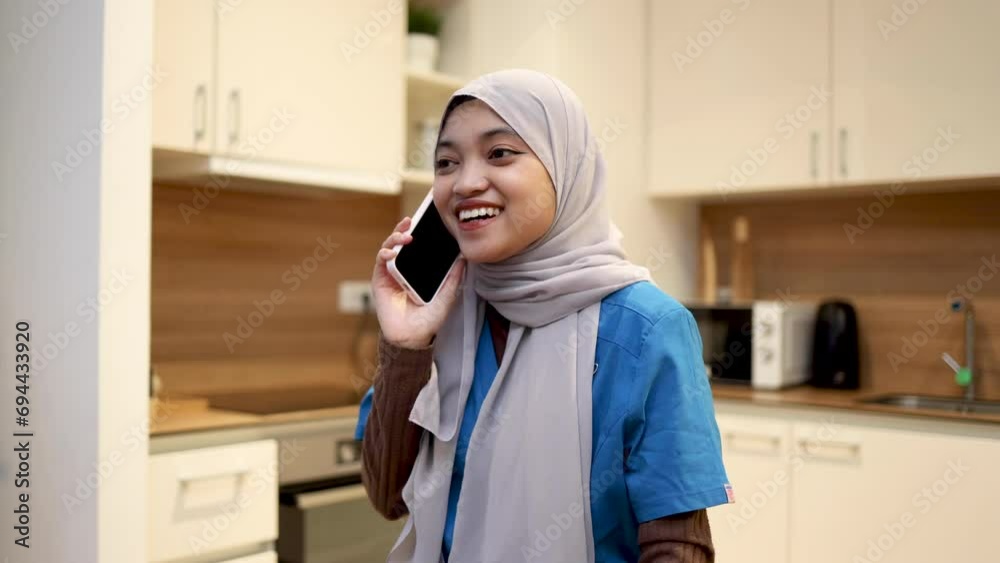 Nurse with hijab talking on the phone Nurse with hijab talking on the phone