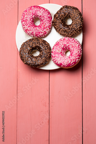 Chocolate and pink donut on a plate, delicious dessert