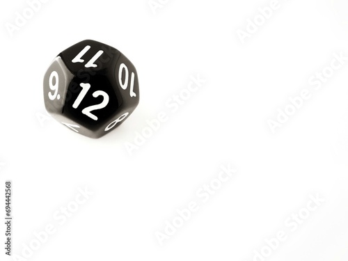 D12 black 12 sided dice isolated on white and copy space. RPG dice. Dodecahedron DND dice