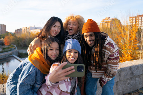 group of friends taking a selfie multiethnic people from different cultures outdoors autumn season