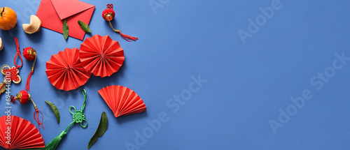 Composition with Chinese fans, red envelope and symbols on blue background. Banner for design photo