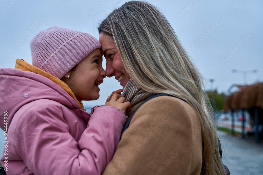 In candid pauses, the mother and daughter share hugs and kisses, creating cherished memories amid their walk.
