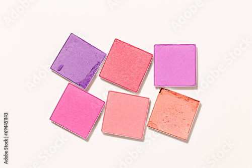 Pink purple colored eyeshadows powder close-up texture, swatches of eye shadow powder or blusher, top view pattern, face makeup powder, woman cosmetics and beauty product, minimal style