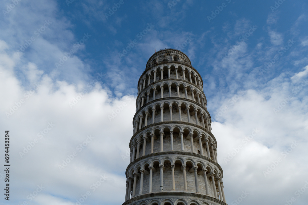 Leaning tower of Pisa against cloudy sky . Tuscany, Italy