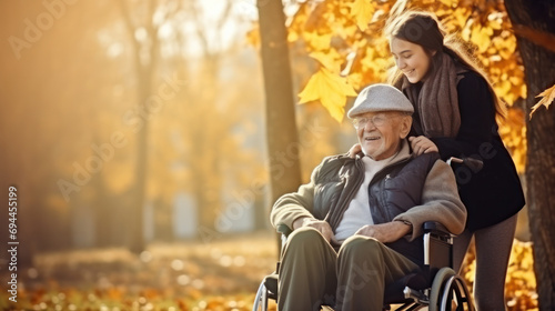 senior man in wheelchair with happy caregiver daughter fall time
