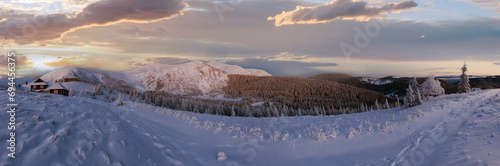 Predawn morning winter mountain panorama with snow covered trees and houses on slope (Carpathian, Ukraine). photo