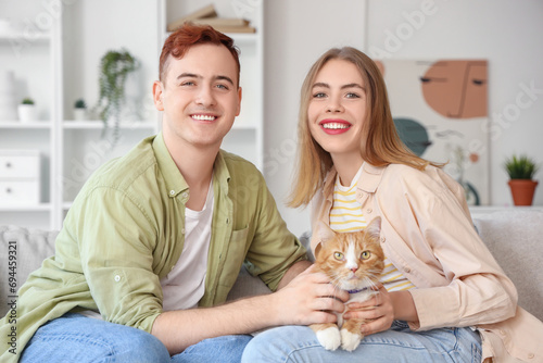 Young couple with cute cat ...