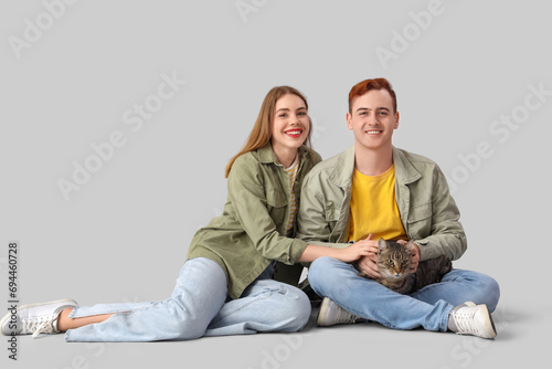 Young couple with cute cat ...