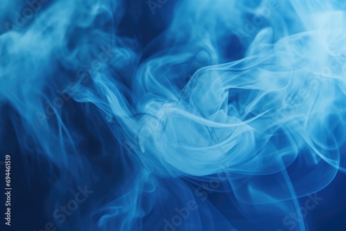 Close up of blue smoke on a black background. Versatile image for various design projects