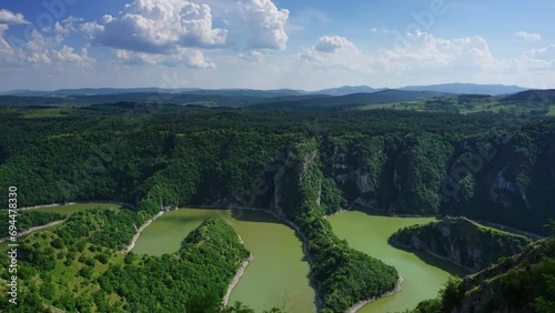 Meanders at rocky river Uvac gorge on sunny day, southwest Serbia, zoom in timelapse 4k photo