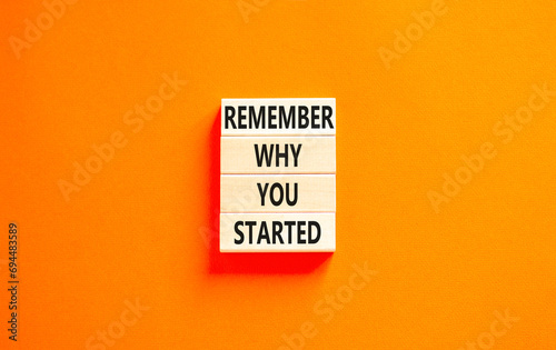 Remember why you started symbol. Concept word Remember why you started on beautiful wooden block. Beautiful orange table orange background. Business remember why you started concept. Copy space.